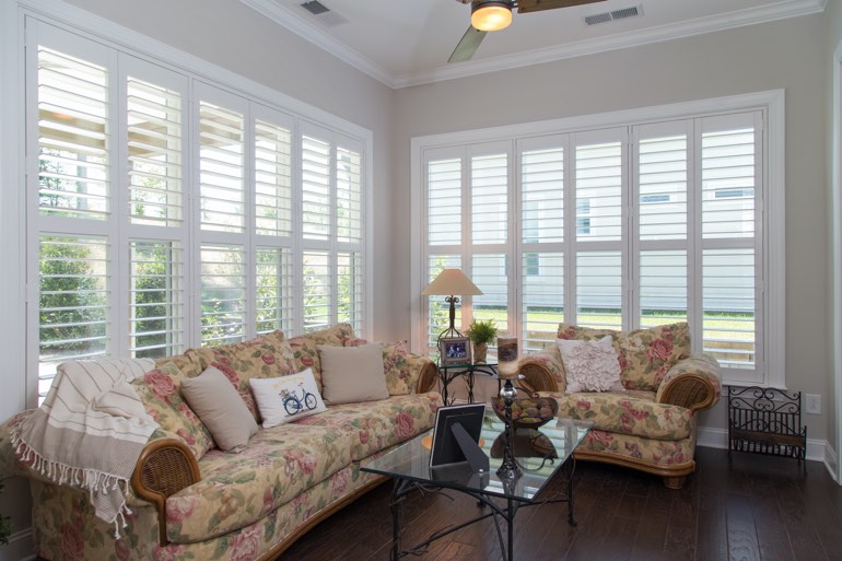 Airy sunroom with faux wood shutters in Destin.